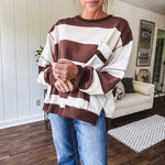 Oversized terry knit long sleeved pullover in brown and ivory large stripes, oversized front pocket, wide hem and cuffs and split hem.