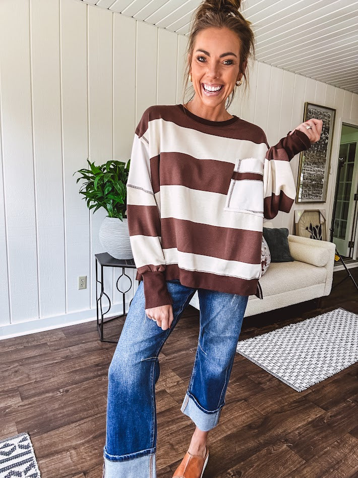 Oversized terry knit long sleeved pullover in brown and ivory large stripes, oversized front pocket, wide hem and cuffs and split hem.