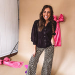 Black button down with tapestry embroidery pattern, ruffled V-neckline, and cuffed, balloon sleeves.