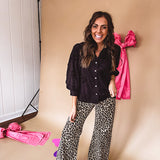 Black button down with tapestry embroidery pattern, ruffled V-neckline, and cuffed, balloon sleeves.