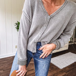 Washed light olive long sleeved rib woven sweater with button front and V neck.