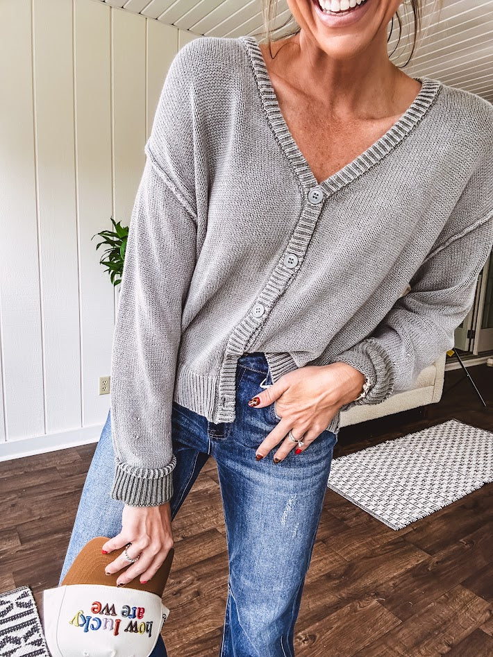 Washed light olive long sleeved rib woven sweater with button front and V neck.
