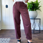 Brown barrel denim with high rise and cuffed hem at the ankle.