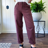 Brown barrel denim with high rise and cuffed hem at the ankle.