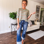 Lightweight, striped drop shoulder sweater tee in a soft sage or rust base  with warm stripes of light brown, taupe, and spice, and ribbed detailing at the neck, cuffs, and hem.