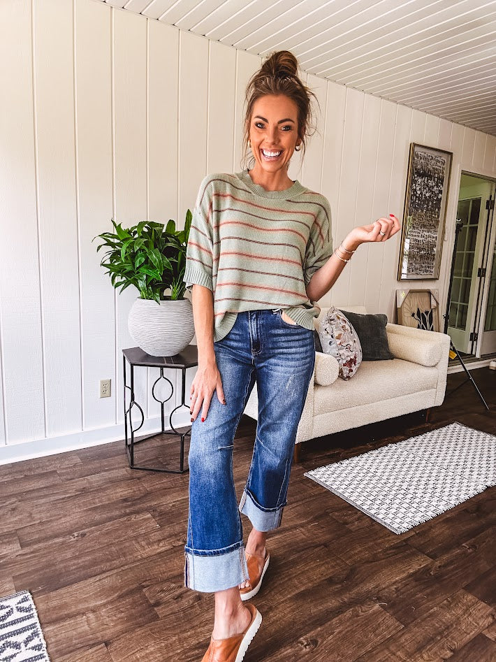 Lightweight, striped drop shoulder sweater tee in a soft sage or rust base  with warm stripes of light brown, taupe, and spice, and ribbed detailing at the neck, cuffs, and hem.