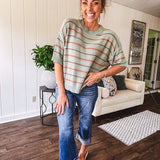 Lightweight, striped drop shoulder sweater tee in a soft sage or rust base  with warm stripes of light brown, taupe, and spice, and ribbed detailing at the neck, cuffs, and hem.