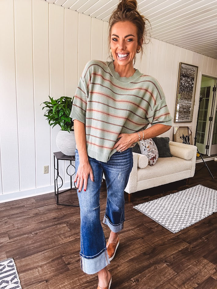 Lightweight, striped drop shoulder sweater tee in a soft sage or rust base  with warm stripes of light brown, taupe, and spice, and ribbed detailing at the neck, cuffs, and hem.
