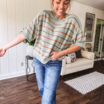 Lightweight, striped drop shoulder sweater tee in a soft sage or rust base  with warm stripes of light brown, taupe, and spice, and ribbed detailing at the neck, cuffs, and hem.
