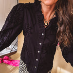 Black button down with tapestry embroidery pattern, ruffled V-neckline, and cuffed, balloon sleeves.