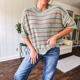 Lightweight, striped drop shoulder sweater tee in a soft sage or rust base  with warm stripes of light brown, taupe, and spice, and ribbed detailing at the neck, cuffs, and hem.