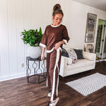 Cocoa brown super soft set with ivory trim at the round neck, cuffs and pleated side trim on the matching pants with elastic waist and pockets. 3/4 sleeve, oversized fit.