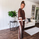 Cocoa brown super soft set with ivory trim at the round neck, cuffs and pleated side trim on the matching pants with elastic waist and pockets. 3/4 sleeve, oversized fit.