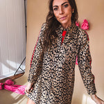 Leo print gold metallic button down dress with red stripes on the sleeves. Metal buttons, a collar, and functional pockets