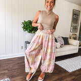 Lightweight cotton balloon style pants with elastic waist and cuffs, side pockets and pastel taupe, pink and coral paisley bandana print.