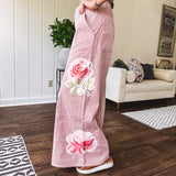 Lightweight blush and cream pinstripe ultra wide leg pants with oversized rose appliques throughout, button and zipper closure with elastic back at the waist, side and back pockets.