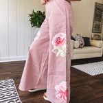 Lightweight blush and cream pinstripe ultra wide leg pants with oversized rose appliques throughout, button and zipper closure with elastic back at the waist, side and back pockets.