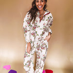 Ivory lounge set with pink, blue, and green florals, a quarter-zip top with kangaroo pocket, mock neck, and hi-low hem and matching bottoms with drawstring waist and pockets.