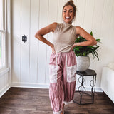 Soft, lightweight cotton pants that blend rose and grey plaid with creamy floral patchwork, lacey cream crochet trim, and a patchwork-trimmed ruffled hemline. Elastic drawstring waist and wide-leg silhouette with lace at the cuffs.