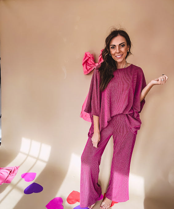 Plum ribbed textured travel set with oversized top with 3/4 sleeves and matching pants with drawstring waist and wide leg.