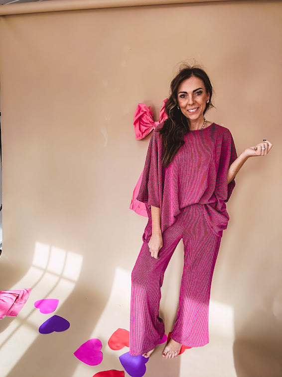Plum ribbed textured travel set with oversized top with 3/4 sleeves and matching pants with drawstring waist and wide leg.