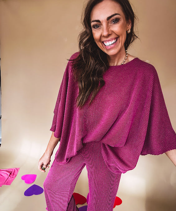 Plum ribbed textured travel set with oversized top with 3/4 sleeves and matching pants with drawstring waist and wide leg.