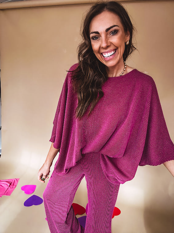 Plum ribbed textured travel set with oversized top with 3/4 sleeves and matching pants with drawstring waist and wide leg.