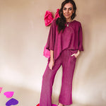 Plum ribbed textured travel set with oversized top with 3/4 sleeves and matching pants with drawstring waist and wide leg.