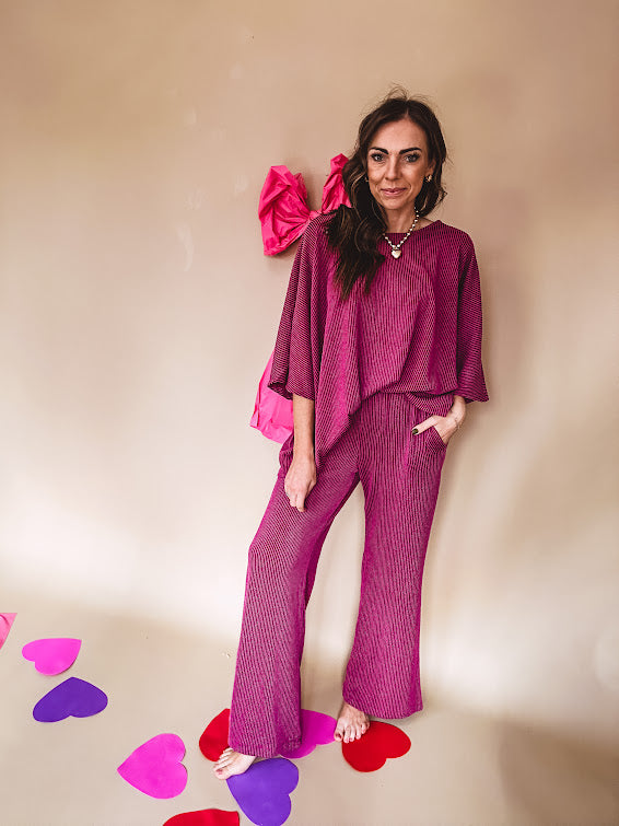 Plum ribbed textured travel set with oversized top with 3/4 sleeves and matching pants with drawstring waist and wide leg.