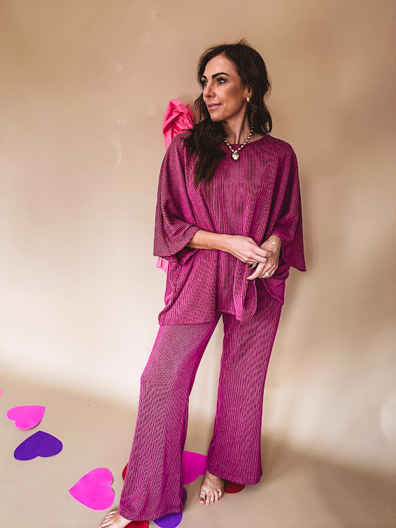 Plum ribbed textured travel set with oversized top with 3/4 sleeves and matching pants with drawstring waist and wide leg.