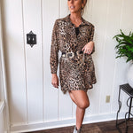 Thin, silky leopard print long blouse/dress with black button front , long sleeves, collar and shimmer detail throughout.
