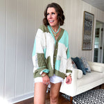 Woven knit button down cardigan with color block patchwork in either mint and green or yellow and taupe.