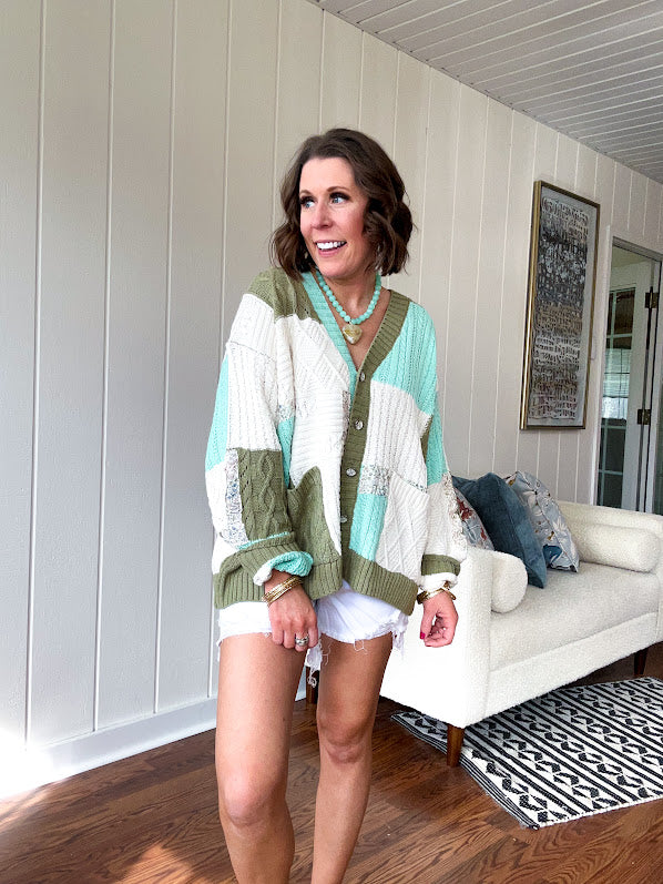 Woven knit button down cardigan with color block patchwork in either mint and green or yellow and taupe.