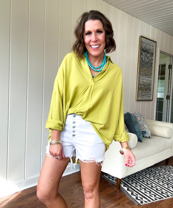 Lime long sleeved top with V neck and collar and relaxed fit, round hem.