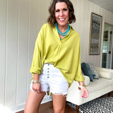 White short inseam raw hem stretchy shorts with button down closure.