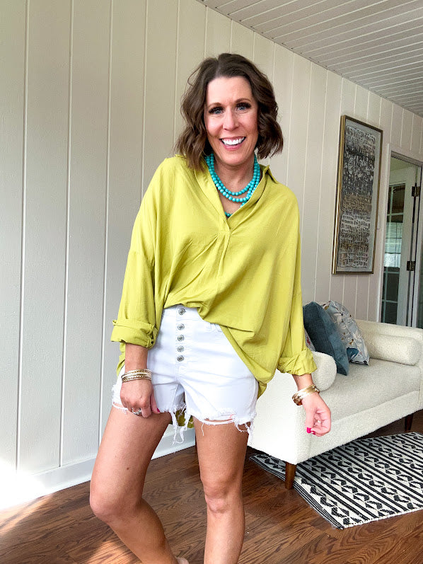 White short inseam raw hem stretchy shorts with button down closure.
