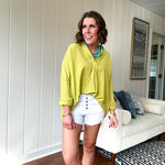 Lime long sleeved top with V neck and collar and relaxed fit, round hem.
