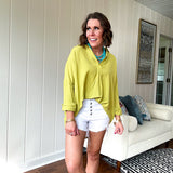 Lime long sleeved top with V neck and collar and relaxed fit, round hem.