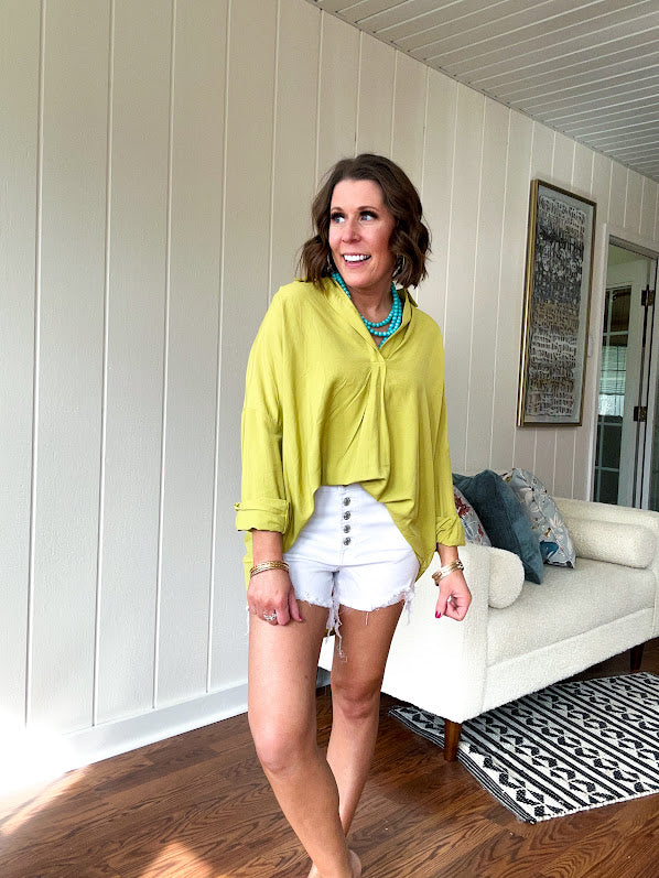 Lime long sleeved top with V neck and collar and relaxed fit, round hem.