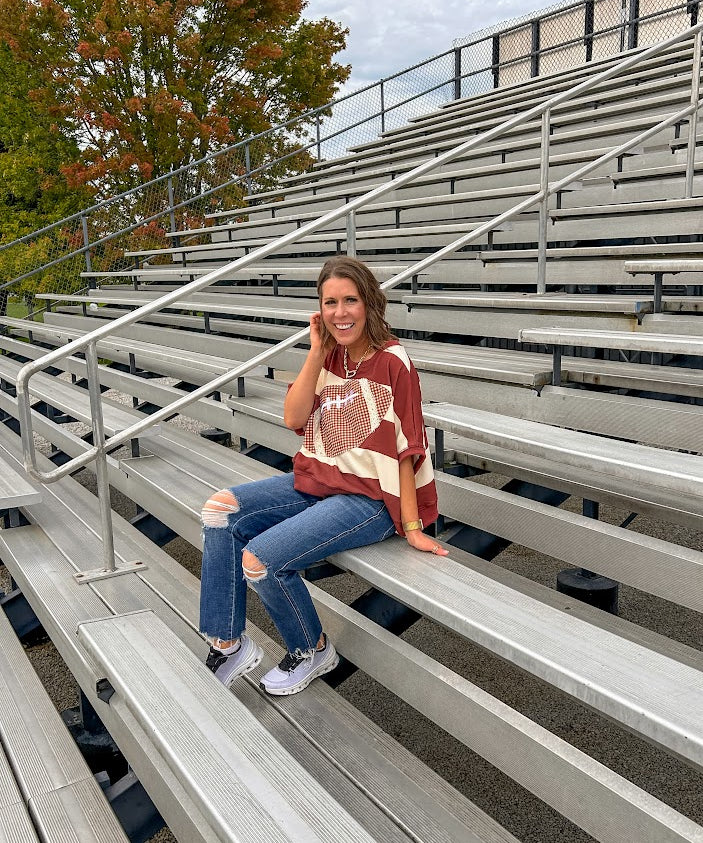 Red brown and cream striped sweatshirt with oversized dolman cut, short sleeves and a gingham football applique trimmed in cream lace.