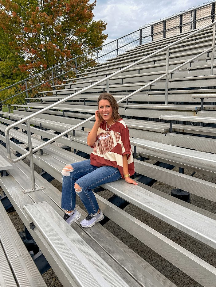 Red brown and cream striped sweatshirt with oversized dolman cut, short sleeves and a gingham football applique trimmed in cream lace.