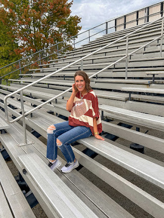 Red brown and cream striped sweatshirt with oversized dolman cut, short sleeves and a gingham football applique trimmed in cream lace.