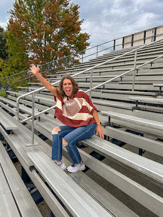 Red brown and cream striped sweatshirt with oversized dolman cut, short sleeves and a gingham football applique trimmed in cream lace.