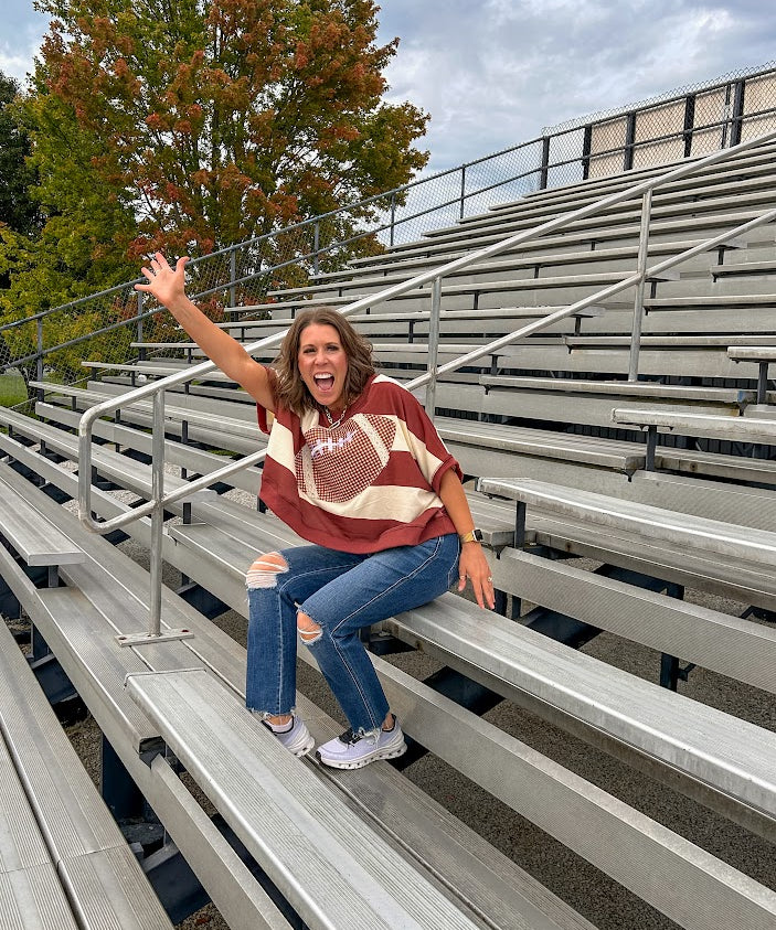 Red brown and cream striped sweatshirt with oversized dolman cut, short sleeves and a gingham football applique trimmed in cream lace.