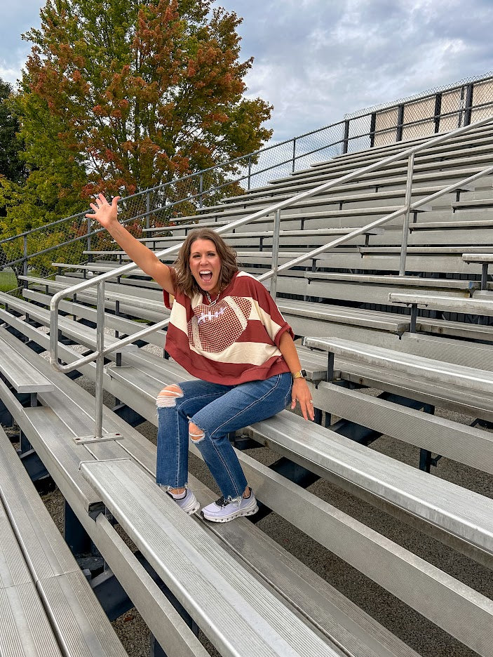 Red brown and cream striped sweatshirt with oversized dolman cut, short sleeves and a gingham football applique trimmed in cream lace.