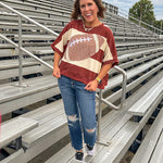 Red brown and cream striped sweatshirt with oversized dolman cut, short sleeves and a gingham football applique trimmed in cream lace.