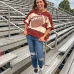 Red brown and cream striped sweatshirt with oversized dolman cut, short sleeves and a gingham football applique trimmed in cream lace.