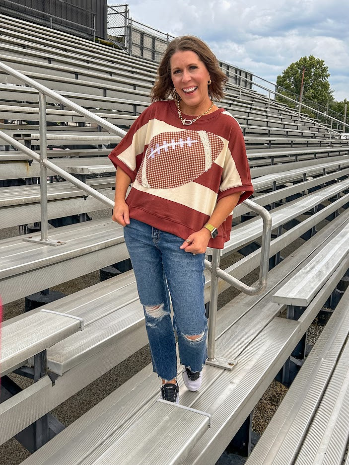 Red brown and cream striped sweatshirt with oversized dolman cut, short sleeves and a gingham football applique trimmed in cream lace.