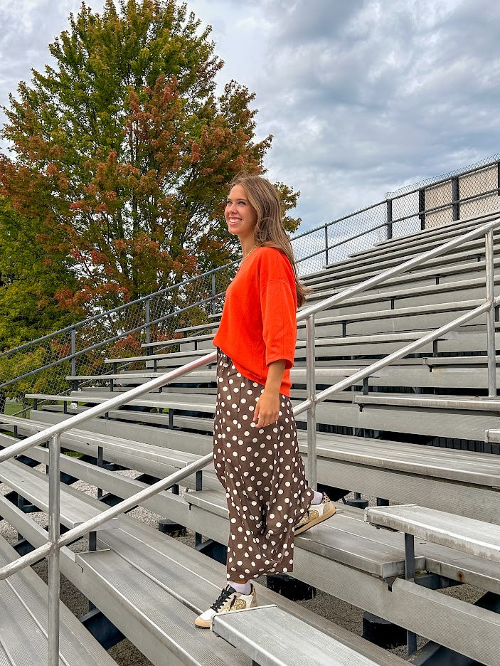 Slick brown with white polka dots balloon style pants with extra volume in the legs and elastic waist.