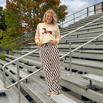 Cream lightweight long sleeved sweater with Weiner Dog graphic on front with orange stripes at the sleeves.